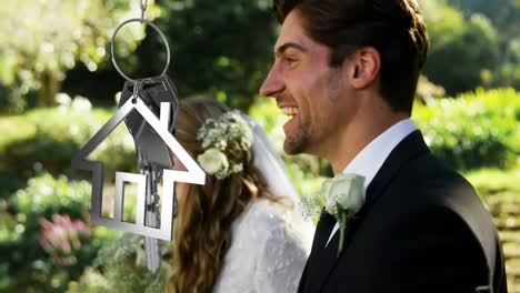 Animation-of-housekey-moving-over-happy-caucasian-couple-walking-towards-aisle-at-wedding