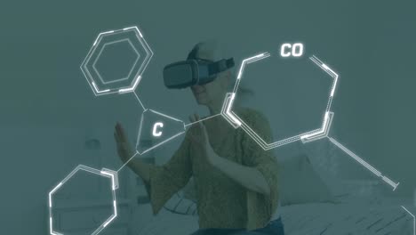 Animation-of-chemical-equations-over-caucasian-woman-using-vr-headset