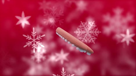 Animation-Eines-Weihnachtlichen-Lebkuchenherzplätzchens-über-Schneeflocken,-Die-Auf-Roten-Hintergrund-Fallen