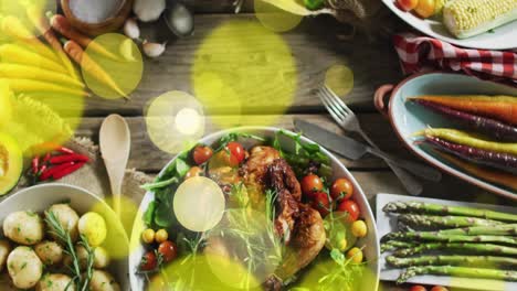 Animation-of-light-spots-over-plates-with-food-on-wooden-background