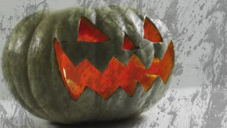 Animation-of-halloween-carved-pumpkin-on-grey-background