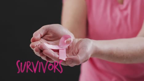 Animation-of-survivors-text-over-caucasian-woman-with-pink-ribbon-on-black-background