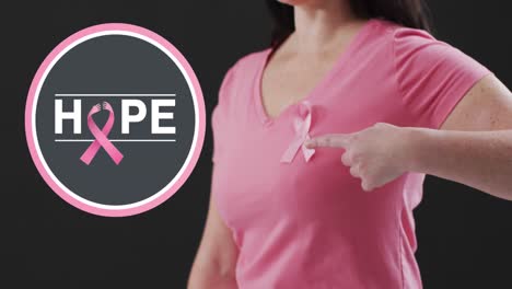 Animation-of-hope-text-over-caucasian-woman-with-pink-ribbon-on-black-background