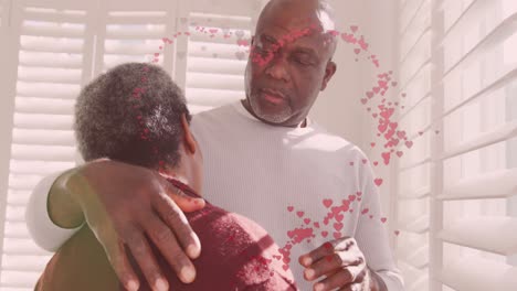 Animation-of-hearts-over-senior-african-american-couple-embracing-at-christmas