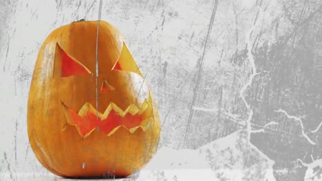 Animation-of-halloween-carved-pumpkin-on-grey-background