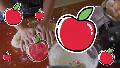 Animation-of-apple-icons-over-hands-with-dough