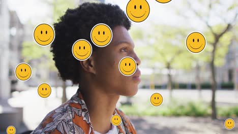 Animation-Von-Emoji-Symbolen-über-Einem-Afroamerikanischen-Mann,-Der-Kaffee-Trinkt