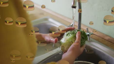Animation-Von-Hamburger-Symbolen-über-Einer-Kaukasischen-Frau,-Die-Salat-Wäscht
