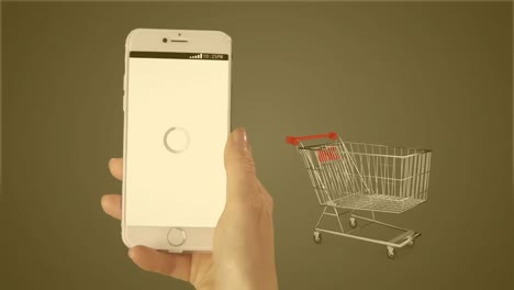 Animation-of-hand-with-smartphone-over-shopping-cart