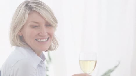 Video-of-smiling-caucasian-woman-drinking-white-wine