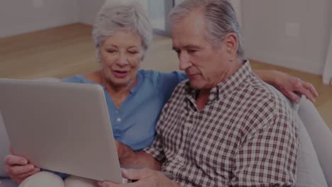 Animation-of-senior-caucasian-couple-using-laptop