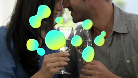 Animation-of-shapes-over-caucasian-couple-with-wine