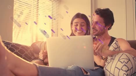 Animation-of-shapes-over-caucasian-couple-using-laptop