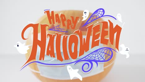 Animation-of-happy-halloween-text-over-pumpkin-with-face-mask
