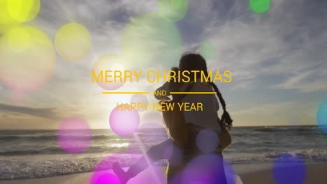 Animation-Eines-Frohe-Weihnachts-Textes-über-Biracial-Mutter-Und-Tochter-Am-Strand