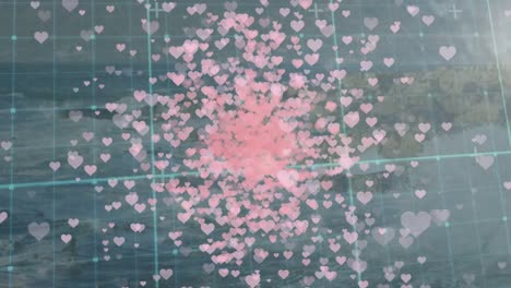Animation-of-pink-hearts-floating-over-grid-and-seascape