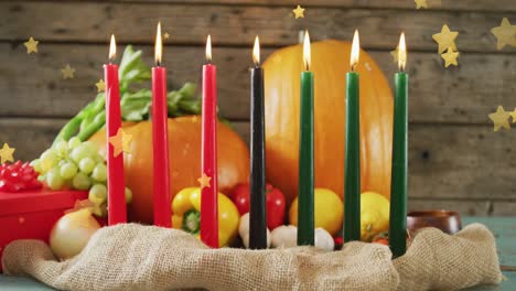 Animation-of-golden-stars-over-kwanzaa-candles-and-pumpkins