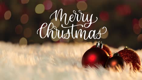 Animation-of-baubles-over-merry-christmas-text