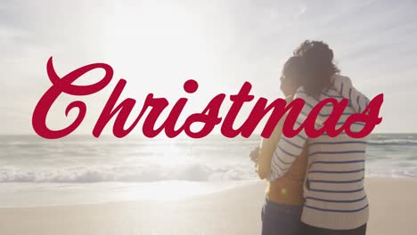 Animation-of-christmas-text-over-biracial-couple-at-beach