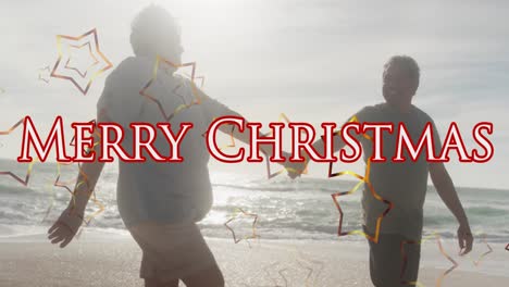 Animation-Eines-Frohe-Weihnachts-Textes-über-Ein-älteres-Gemischtrassiges-Paar-Am-Strand