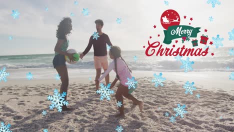 Animation-of-merry-christmas-text-and-snow-falling-over-biracial-family-at-beach