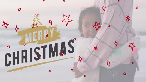 Animation-of-merry-christmas-text-over-biracial-mother-and-daughter-at-beach