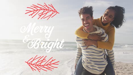 Animation-of-merry-and-bright-text-over-biracial-couple-at-beach