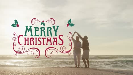 Animation-of-merry-christmas-text-over-senior-biracial-couple-at-beach
