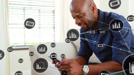Animation-of-network-of-connections-with-icons-over-happy-african-american-man-with-smartphone