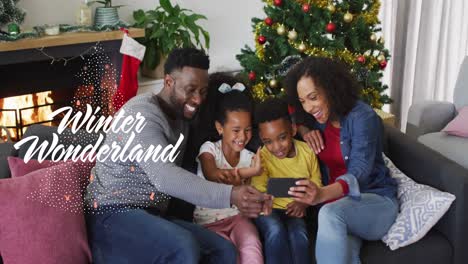 Animation-of-winter-wonderland-text-over-african-american-family-smiling