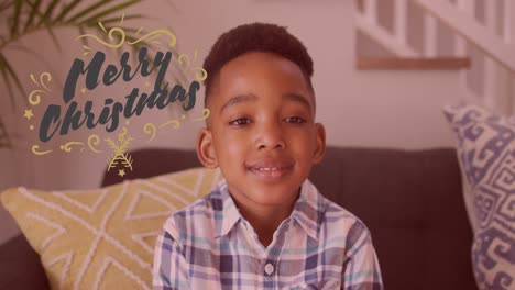 Animation-of-merry-christmas-text-over-african-american-boy-smiling