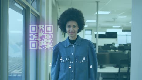 Animation-of-gr-code-and-icons-over-biracial-woman-smiling-in-office