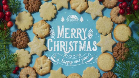 Animation-of-merry-christmas-over-cookies-on-blue-surface