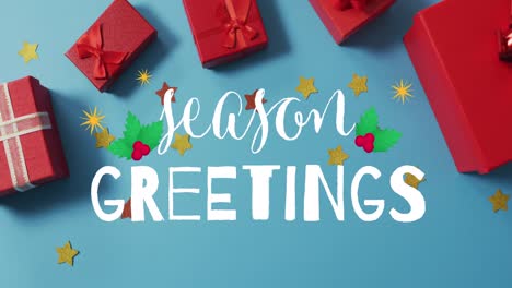 Animation-of-season-greetings-over-presents-on-blue-surface
