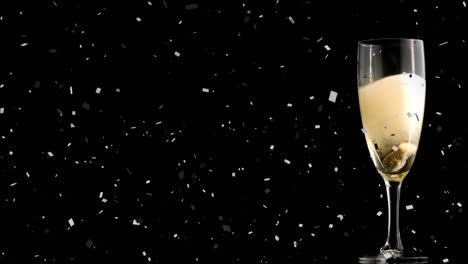 Animation-of-falling-confetti-with-glass-filled-with-champagne-over-black-background