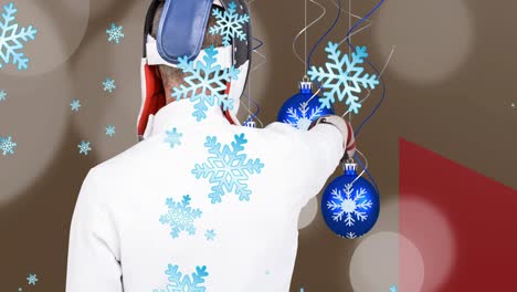 Animation-of-caucasian-man-and-baubles-over-snow-falling