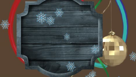 Animation-of-wooden-sign-and-baubles-over-snow-falling