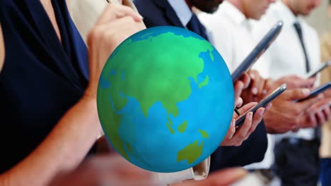 Animation-of-globe-over-diverse-business-people-using-smartphones