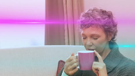 Animation-of-light-trails-over-caucasian-woman-drinking-coffee