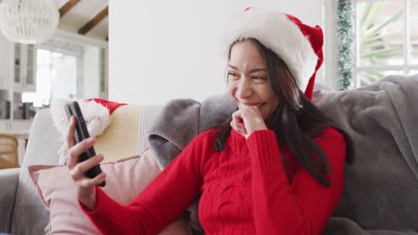 Biracial-woman-with-santa-hat-having-video-call