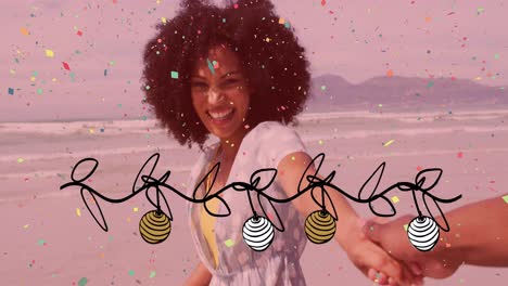 Animation-of-christmas-confetti-and-decorations-over-happy-biracial-woman-laughing-on-sunny-beach