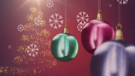 Animation-of-shiny-baubles-with-falling-snowflakes-and-gold-christmas-tree-on-red-background