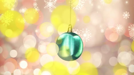 Animation-of-shiny-blue-christmas-bauble-with-white-snowflakes-and-yellow-spots-of-light