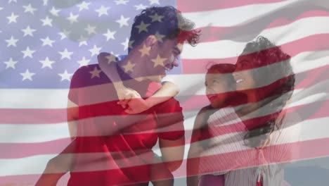 Animation-of-flag-of-united-states-of-america-over-biracial-couple-carrying-children-piggyback