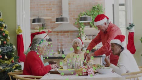 Animation-of-green-dots-over-happy-diverse-senior-friends-in-santa-hats-eating-together
