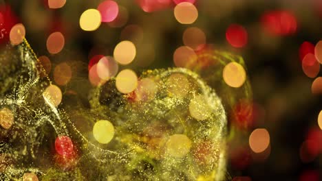 Animation-of-floating-gold-dust-over-defocussed-flashing-yellow-and-red-christmas-lights