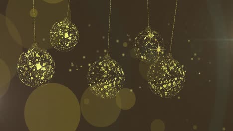 Animation-of-gold-christmas-baubles-swinging-over-stars-and-light-spots-on-brown-background