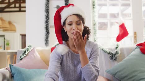 Portrait-of-happy-african-american-woman-with-santa-hat-having-video-call