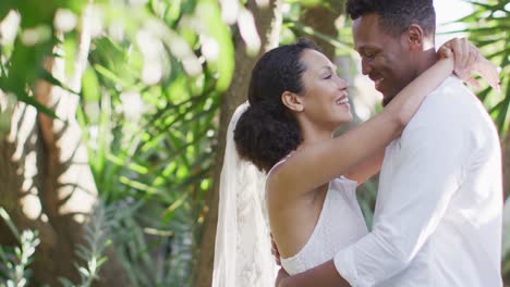 Glückliches-Afroamerikanisches-Ehepaar,-Das-Sich-Umarmt-Und-Hochzeitskleidung-Trägt