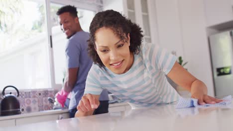 Happy-african-american-couple-washing-dishes-in-kitchen